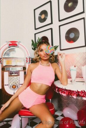 Pia Mia Leaning On a Giant Bubblegum Machine